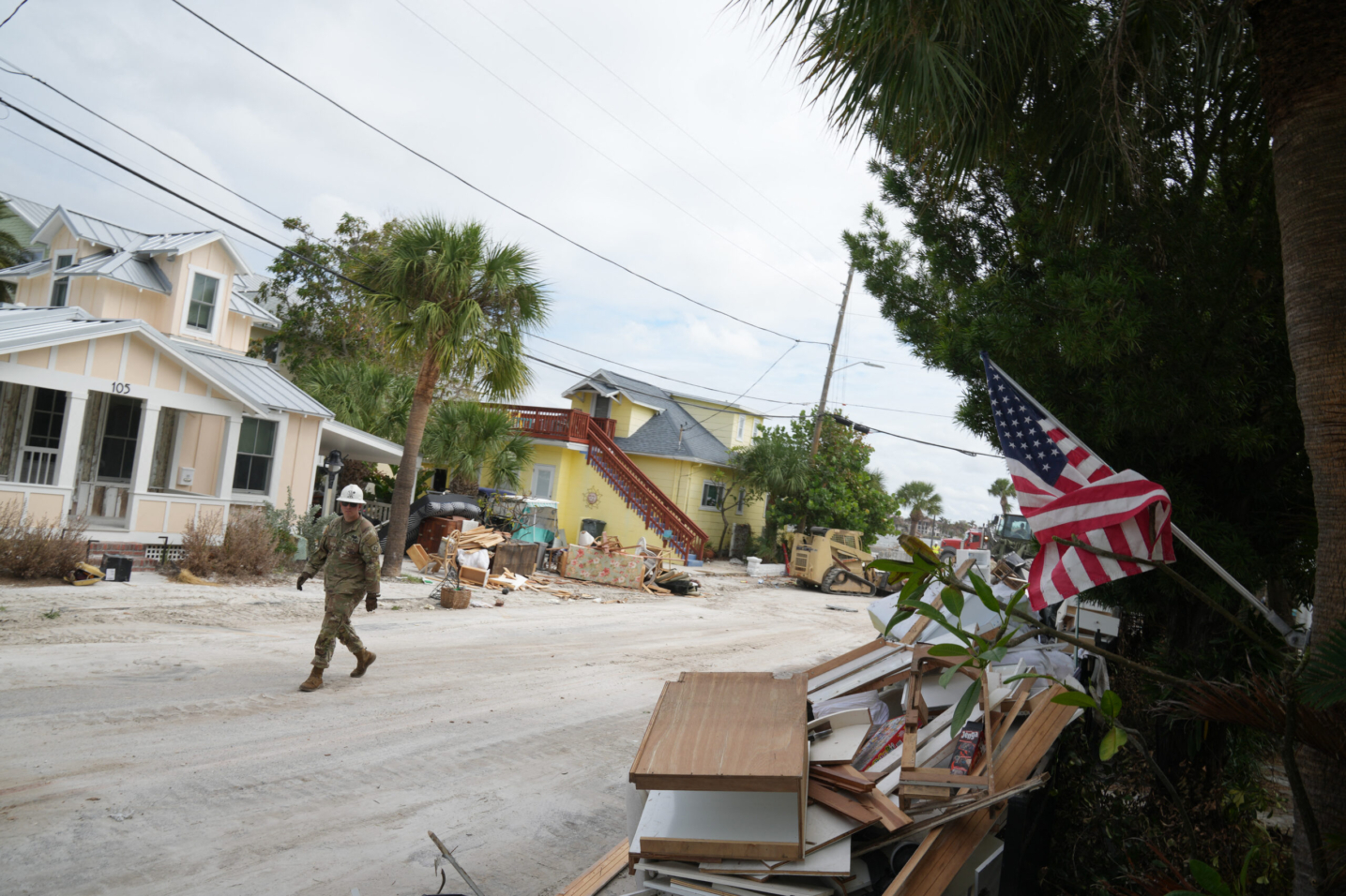 A member of the Florida Army National Guard during debris removal in the Pass-A-Grille section of St. Petersburg ahead of Hurricane Milton's expected landfall in the middle of this week on October 7, 2024 in Florida. - Florida's governor has declared a state of emergency on Saturday as forecasters warned that Hurricane Milton is expected to make landfall later this week. (Photo by Bryan R. SMITH / AFP)